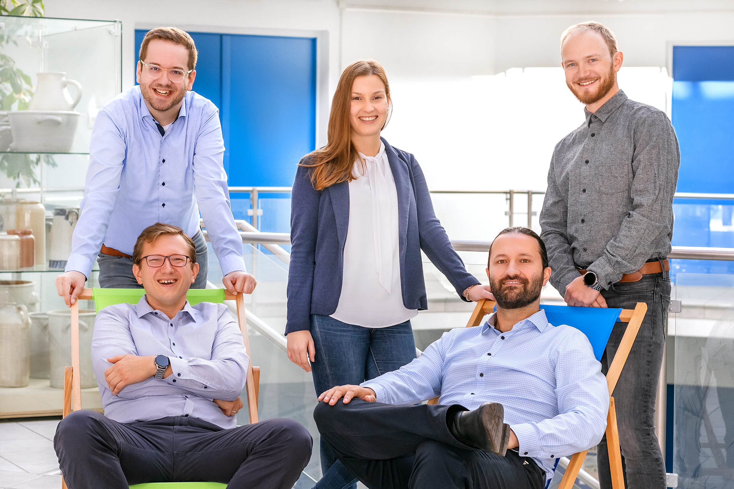members of the Hilgenberg Ceramics team smiling in a bright office space