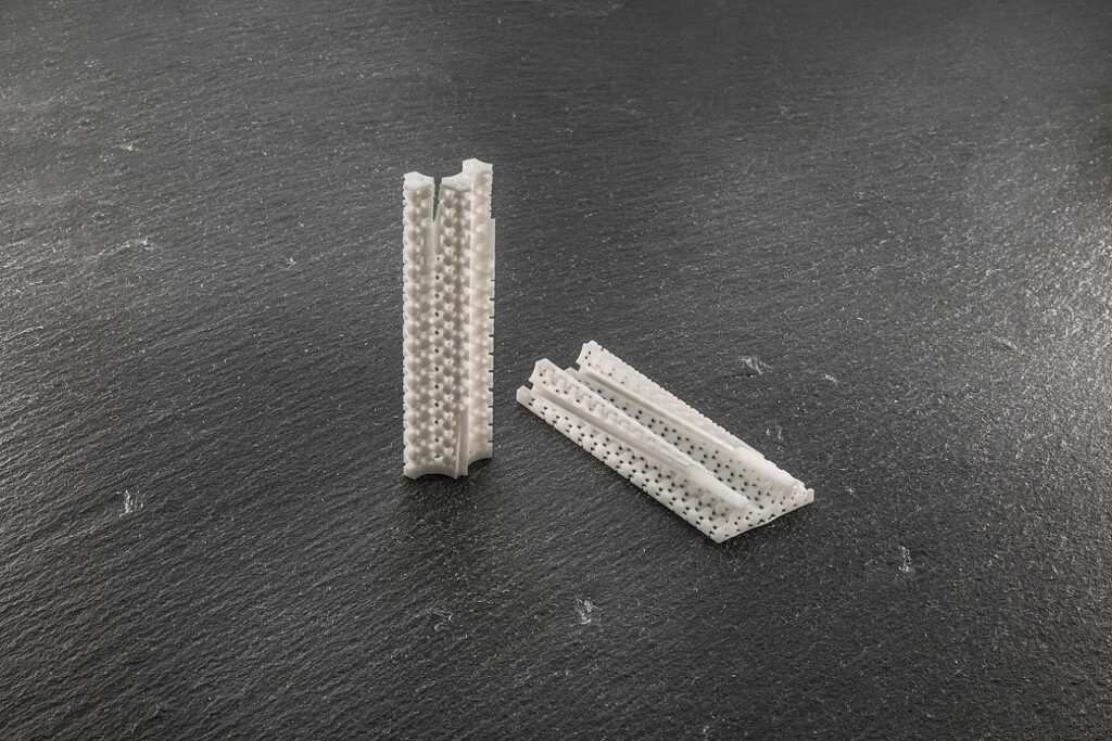 Detailed view of two 3D-printed zirconia flow resistors for nuclear reactor coolant simulations
