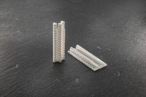 Detailed view of two 3D-printed zirconia flow resistors for nuclear reactor coolant simulations