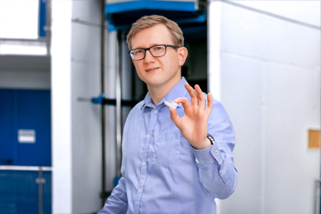 3D-printed ceramic plasma nozzle being presented in an industrial environment